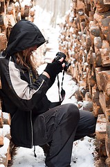 Image showing Photographer between logs of wood