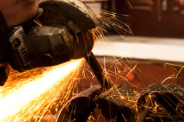 Image showing Close up of a metal sawing machine with sparks