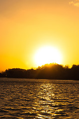 Image showing Sunset on the horizon with water reflecting rays