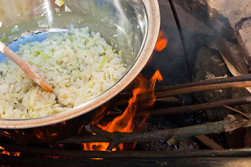 Image showing Onions boiling in campfire