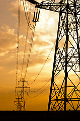 Image showing Angle shot of power lines against sunset in the background