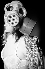 Image showing Girl in gasmask and lingerie against black background in black a