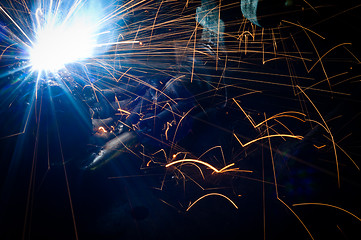 Image showing Hot sparks at grinding steel material