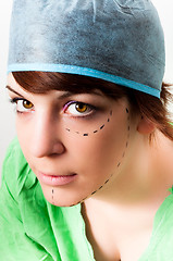 Image showing Drawn lines on a young woman face as marks for facial plastic su