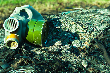 Image showing Vintage gasmask on burnt down ground