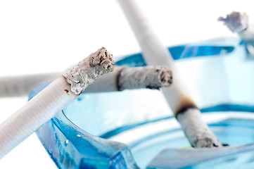 Image showing Closeup image of ashtray and cigarettes, isolated on white backg