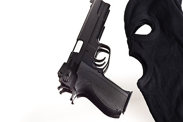 Image showing Pistol and mask of a thief over white