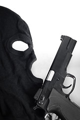 Image showing Pistol and mask of a thief over white