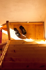 Image showing A pair of slippers on stairs in morning light