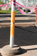 Image showing Fresh asphalt isolated from road with barricade