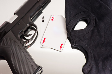 Image showing A pair of aces with a mask and a pistol of a thief