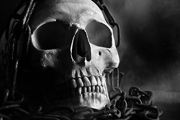 Image showing human skull with chain and smoke in black and white