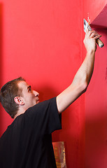 Image showing Painter working on wall