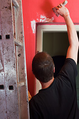 Image showing Painter working on wall with ladder in focus