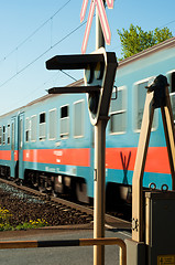 Image showing train passing trough station with focus on lamp