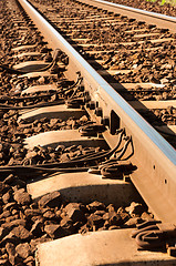 Image showing Close up shot of a rusty rails with wires attached to them