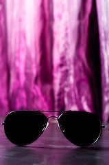 Image showing Sunglasses against purple blurry background