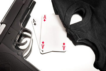 Image showing Pistol and mask of a corrup poker player