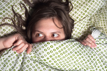 Image showing Girl in bed at home hiding under the blanket