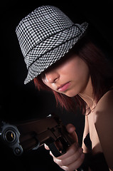 Image showing Girl with hat pointing gun