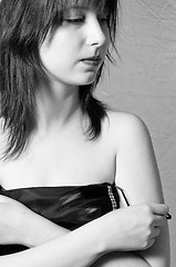 Image showing A beautiful young girl undressing in black and white