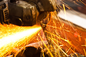 Image showing Machine cutting metal with sparks