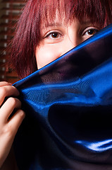 Image showing Girl holding blue scarf before her face