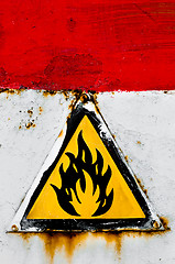 Image showing Beware of fire sign on rusty metal