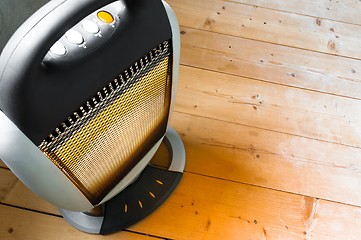 Image showing Halogen or infra heater in action against wooden floor