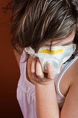 Image showing Girl wearing protective mask against flu or radiation
