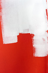Image showing White paint over red wall