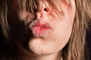 Image showing Beautiful young girl kissing with sugar on her mouth