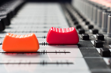 Image showing Orange and  red slider on a sound mixer