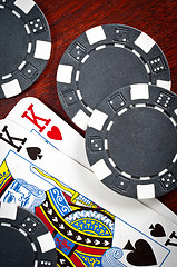 Image showing A pair of kings and some tokens on wood background