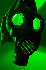 Image showing A military gasmask in green light
