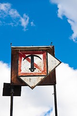 Image showing Rusty sign with boat anchor against blue sky