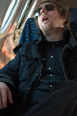 Image showing Portrait of a young man sleeping in a seat of an airplane