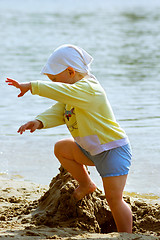 Image showing Baby girl playing on the sea shore