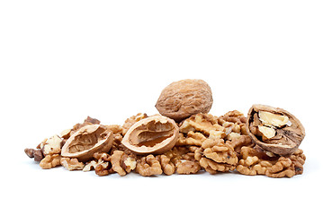 Image showing Whole and cracked walnuts with nutshells over kernels