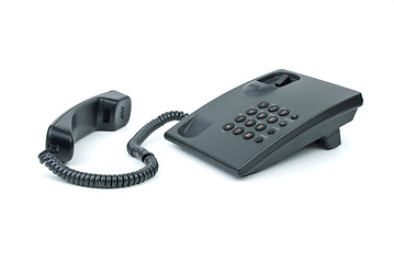 Image showing Black office phone with handset near