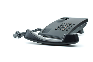 Image showing Black office phone with handset in foreground