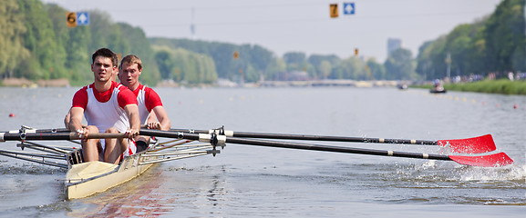 Image showing Rowers and oars