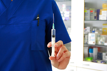 Image showing Vaccination concept. Nurse is holding syringe