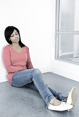 Image showing Tired woman sitting on the floor