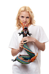 Image showing beautiful girl with a wooden dragon