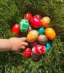 Image showing Hand taking Easter egg