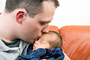 Image showing Happy Father Kisses His Newborn Baby