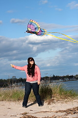 Image showing Girl Flying a Kite at the Beach