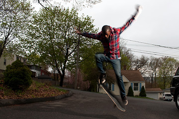 Image showing Skateboarder Man Doing an Ollie Jump