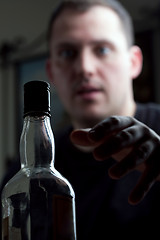 Image showing Man Reaching For the Liquor Bottle